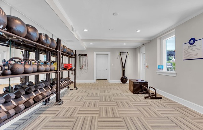 a large room with shelves of helmets and other equipment on the wall and a window at Madison Brookhaven, Atlanta, GA, 30329