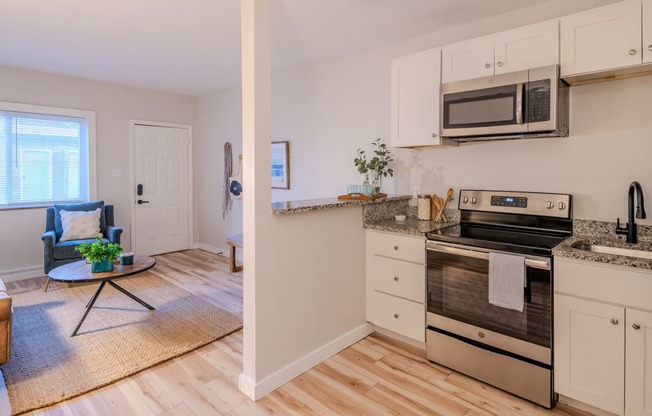 a kitchen with stainless steel appliances and white cabinets