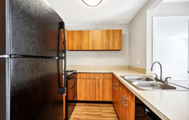 a kitchen with a sink and a refrigerator