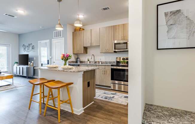 A kitchen with stainless steel appliances and wooden cabinets.