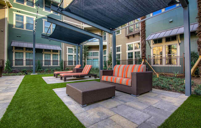 a patio with furniture and awnings at the bradley braddock road station apartments