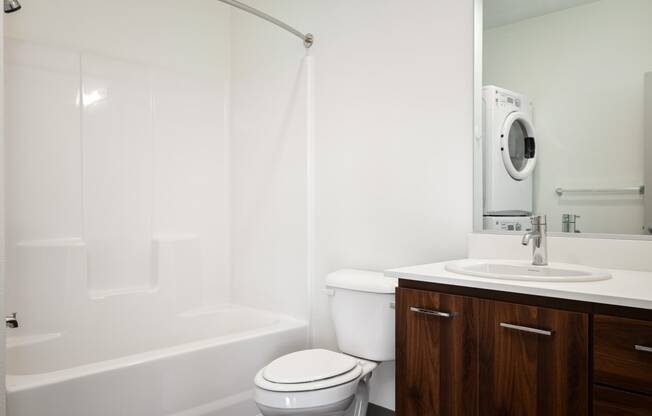 a bathroom with a toilet and a sink and a bath tub