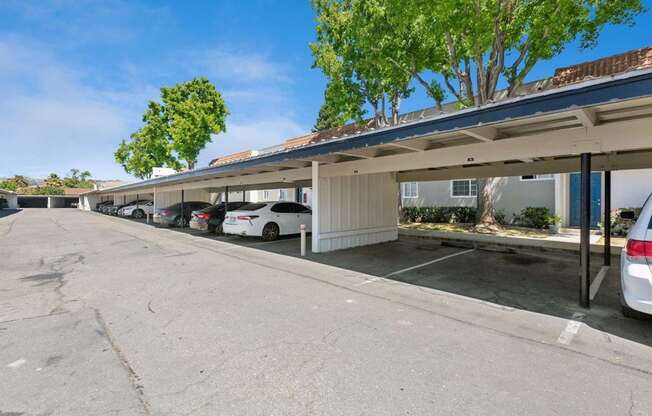 A covered parking lot with cars parked