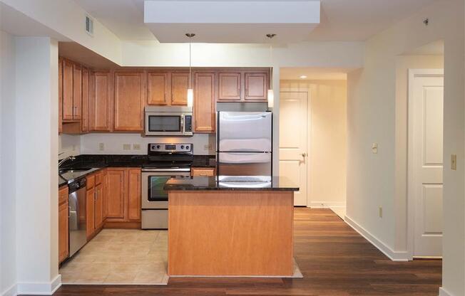 a large kitchen with wooden cabinets and a refrigerator