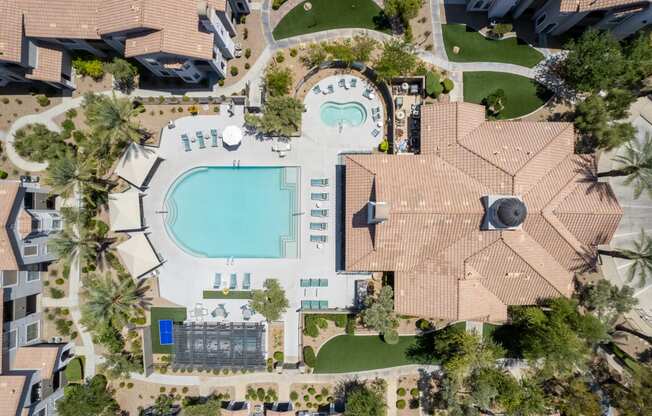 a birds eye view of a mansion with a swimming pool in the backyard