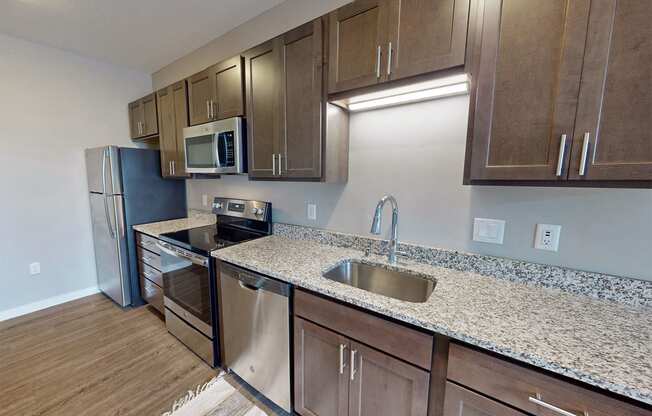 a kitchen with granite counter tops and stainless steel appliances