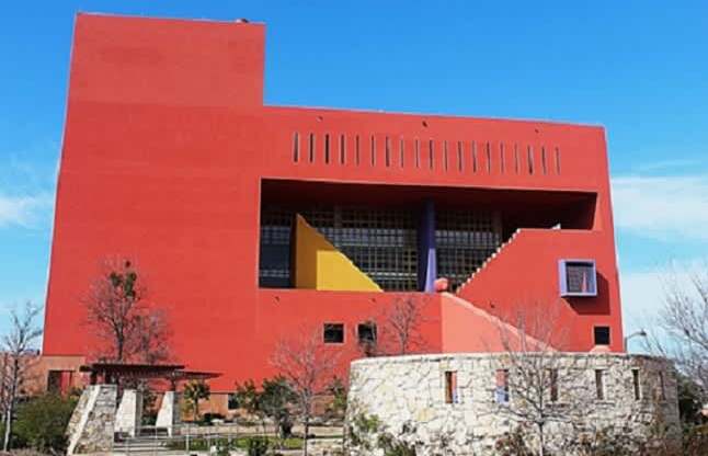 A red building with a yellow triangle on the front.