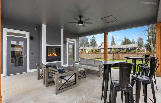 A patio with a fireplace and seating area.