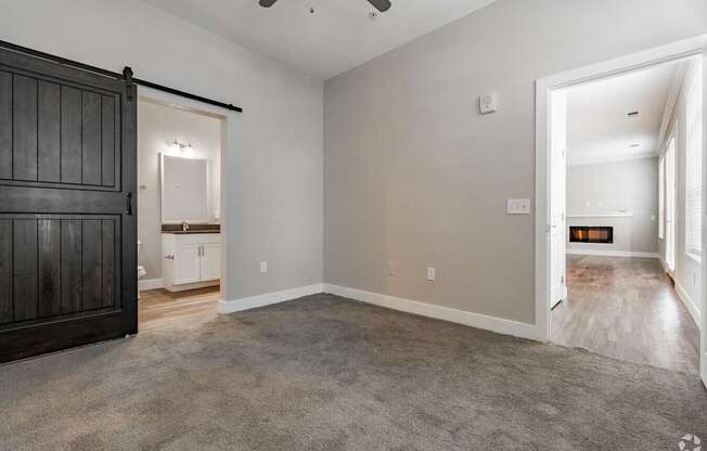 A room with a carpeted floor and a ceiling fan.at Century Baxter Avenue, Louisville