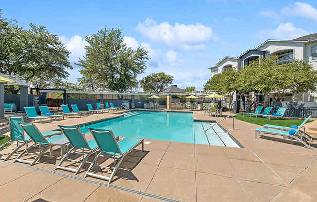 Community Swimming Pool with Pool Furniture at Allure North Dallas Apartments in Dallas, TX.
