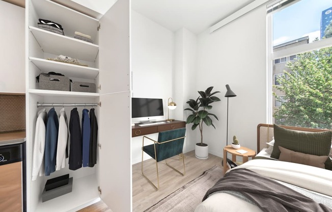 a bedroom with a desk and a closet and a window