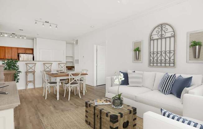 A white living room with a dining table and chairs.