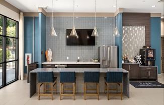 A modern kitchen with a dark blue backsplash and a central island.