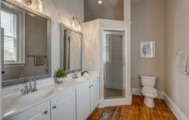 A bathroom with a white sink and a white toilet.