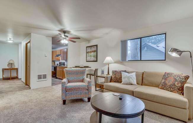 A living room with a couch, chair, and coffee table.