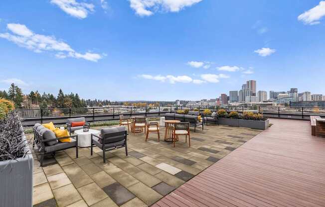 A rooftop patio with a view of the city skyline.