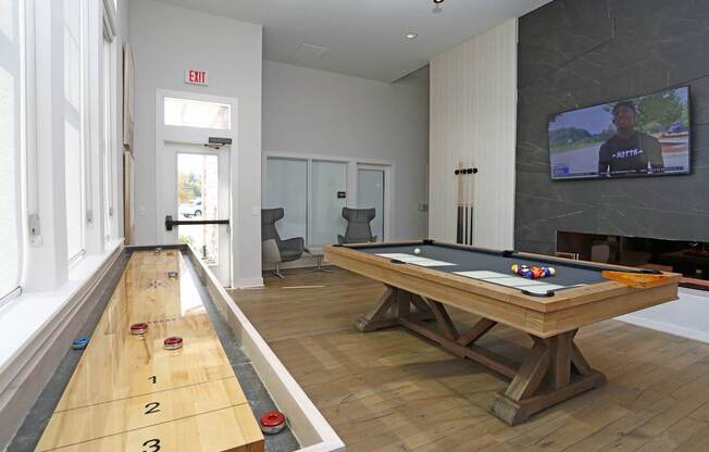 Gaming lounge with fireplace and TV