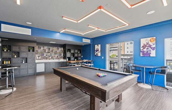 a games room with a pool table and a bar