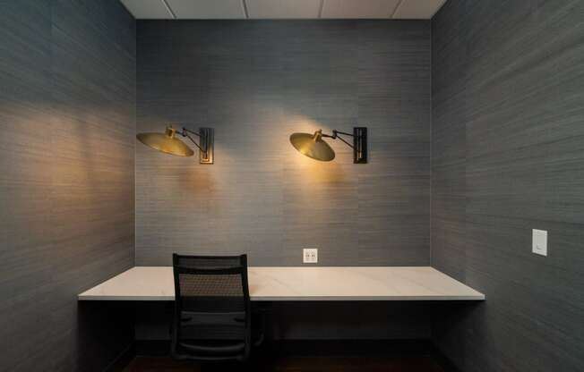 Private resident workspace with built-in desk, two gold wall sconces, and outlets at Sylvan Uptown, Denver, CO, 80203