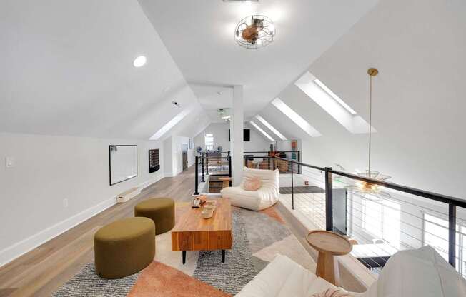 A living room with a white couch and a brown coffee table.