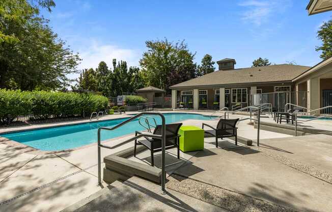 the preserve at ballantyne commons pool and patio with chairs and a pool house