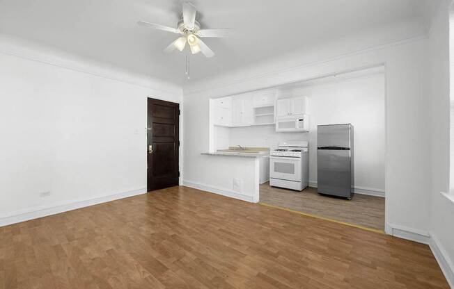 A room with a ceiling fan and a kitchenette at Pleasant Oak Apartments, Oak Park