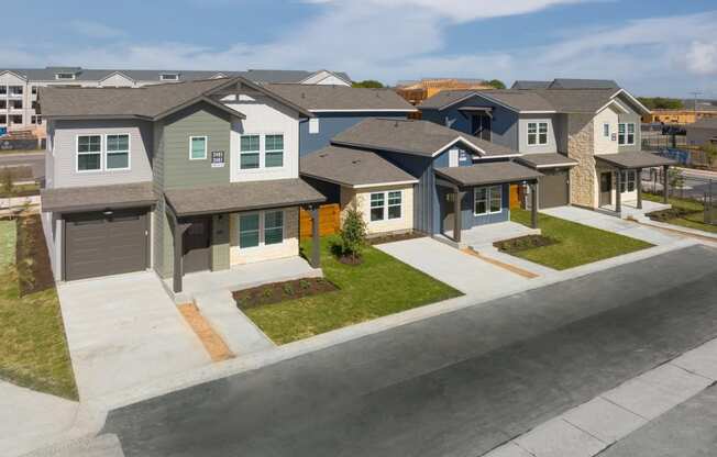 an aerial view of a group of houses on a street