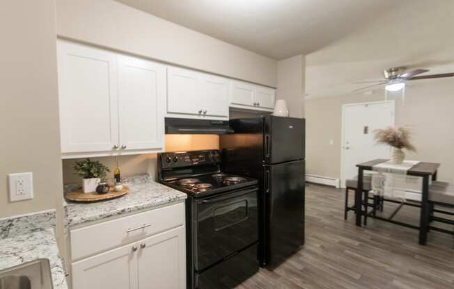 This is picture of the kitchen and dining area in the 823 square foot 2 bedroom apartment at Aspen Village Apartments in the Westwood neighborhood of Cincinnati, OH.