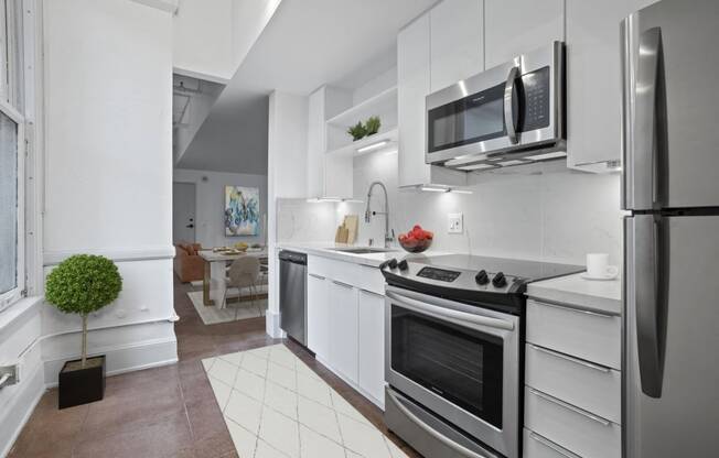 a kitchen with white cabinetry and stainless steel appliances