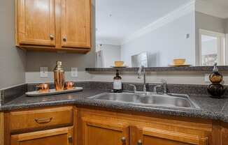 a kitchen with a sink and wooden cabinets