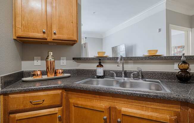 a kitchen with a sink and wooden cabinets