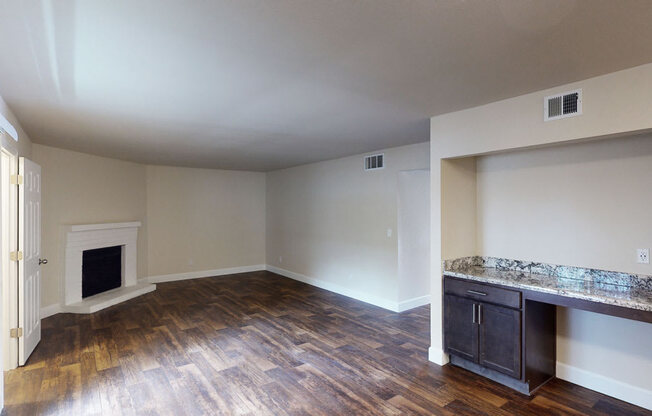 a living room with hardwood floors and a fireplace
