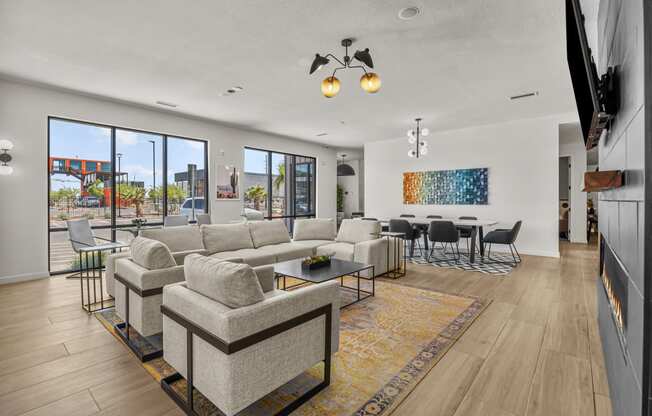 a living room with a couch and a coffee table and a dining room with chairs