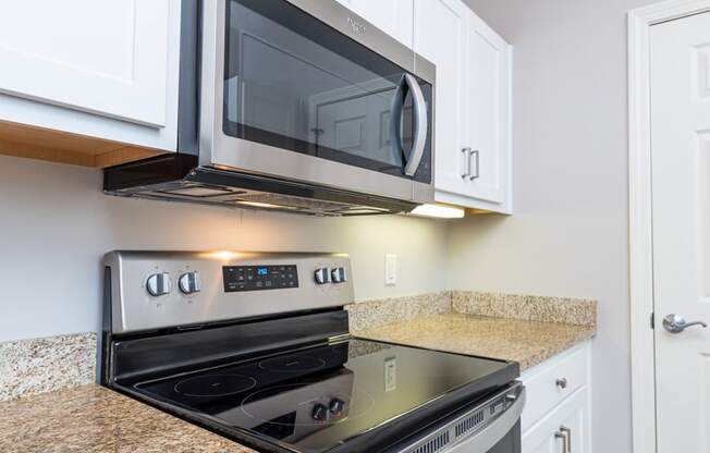 Drum Hill 2 Bedroom Apartment Kitchen with stainless steel range and microwave, granite counters