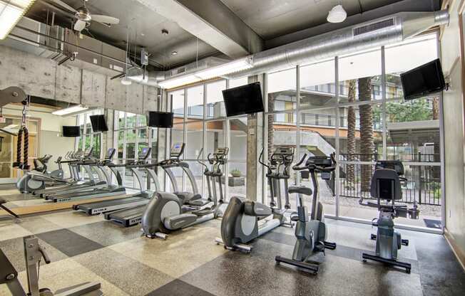 an image of a gym with treadmills and other exercise equipment