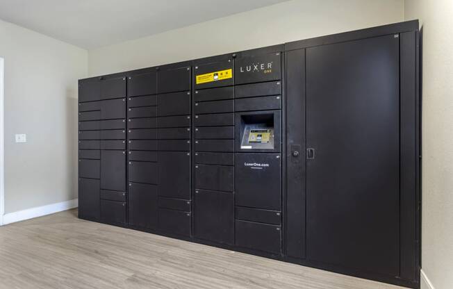 a large set of black lockers in the corner of a room