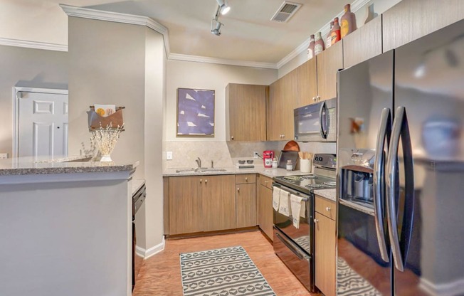 a kitchen with stainless steel appliances and wooden cabinets at Cypress River, South Carolina, 29456