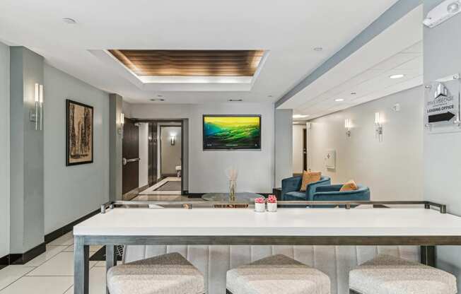 a bar with four stools in a living room with a couch and a television