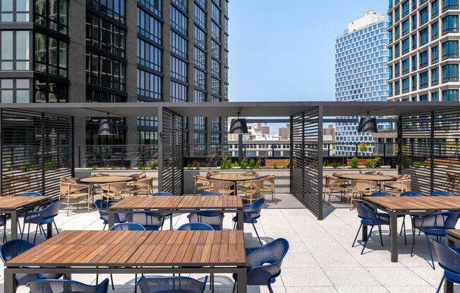 Dining tables and cabanas on the BBQ terrace at 595 Dean St apartments 