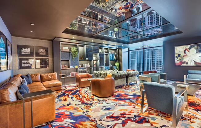 30th-floor club room with designer furnishings, a statement ceiling feature, and panoramic Atlanta views creating an unforgettable setting for gathering and relaxation.