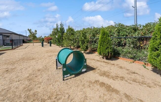 a park with a green playground and trees