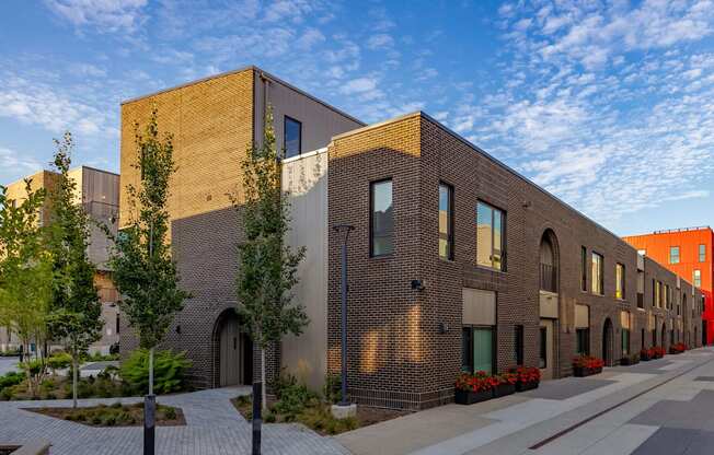 A long building with a lot of windows and a brick facade.