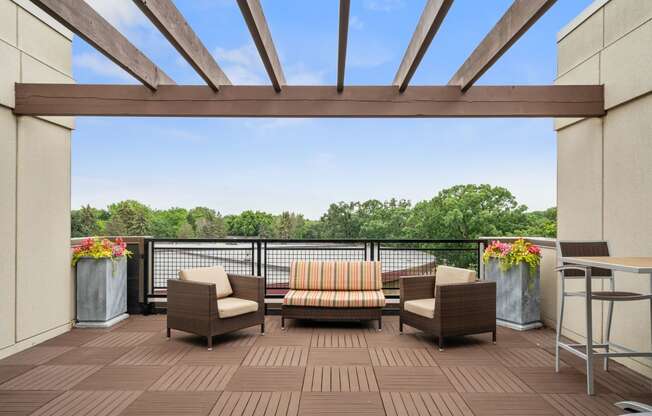 a patio with chairs and a table on a balcony