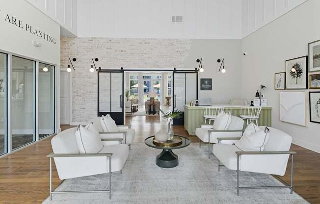 A white room with a table and chairs in the middle.