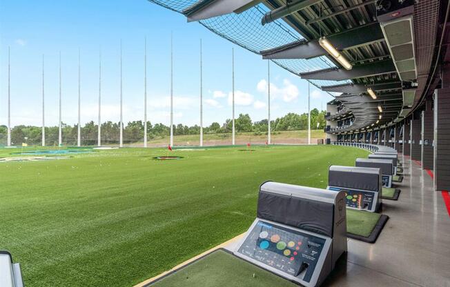 a view of a soccer field from the dugout of an empty stadium