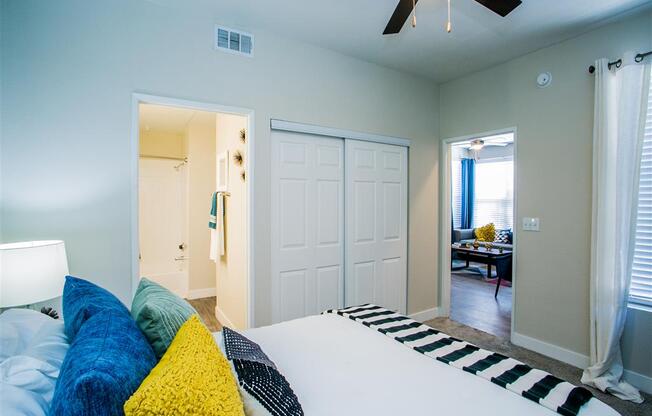 a bedroom with a bed and a ceiling fan