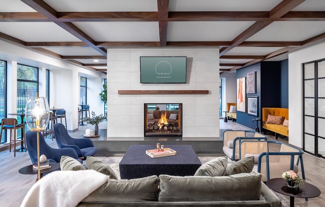 Seating in front of dual sided fireplace and TV in clubroom