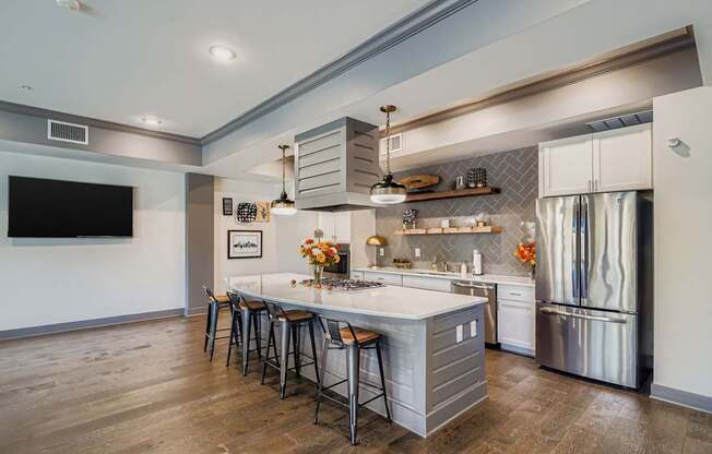 A modern kitchen with a large island and stainless steel appliances.