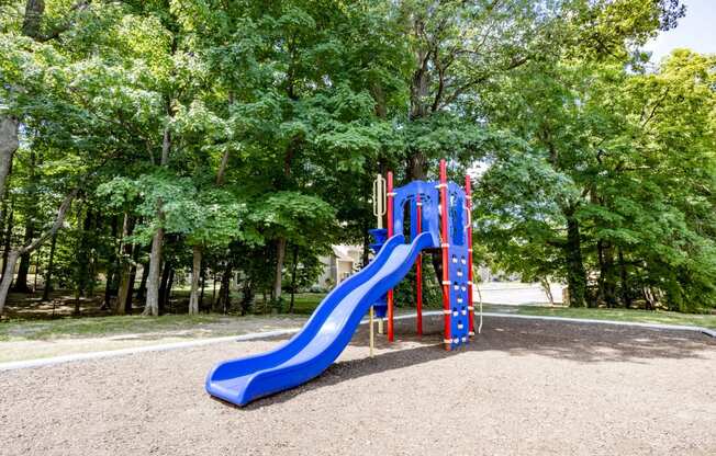 Playground with a slide and climbing apparatus at Woodbridge Apartments