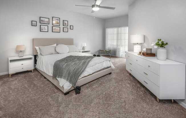 spacious bedroom is decorated with white furniture and has a large bed and carpet , Henley Tampa Palms, Tampa, FL